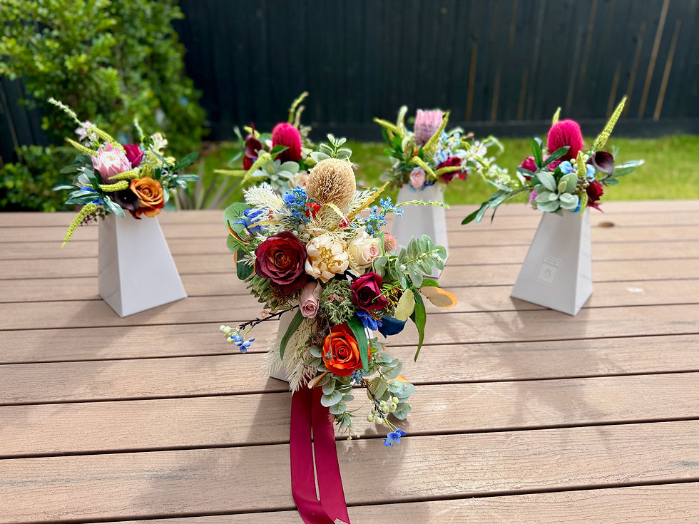 Thumbnail: Outdoors shot of JW Weddings Australia native rustic artificial bridal and bridesmaid bouquet package.