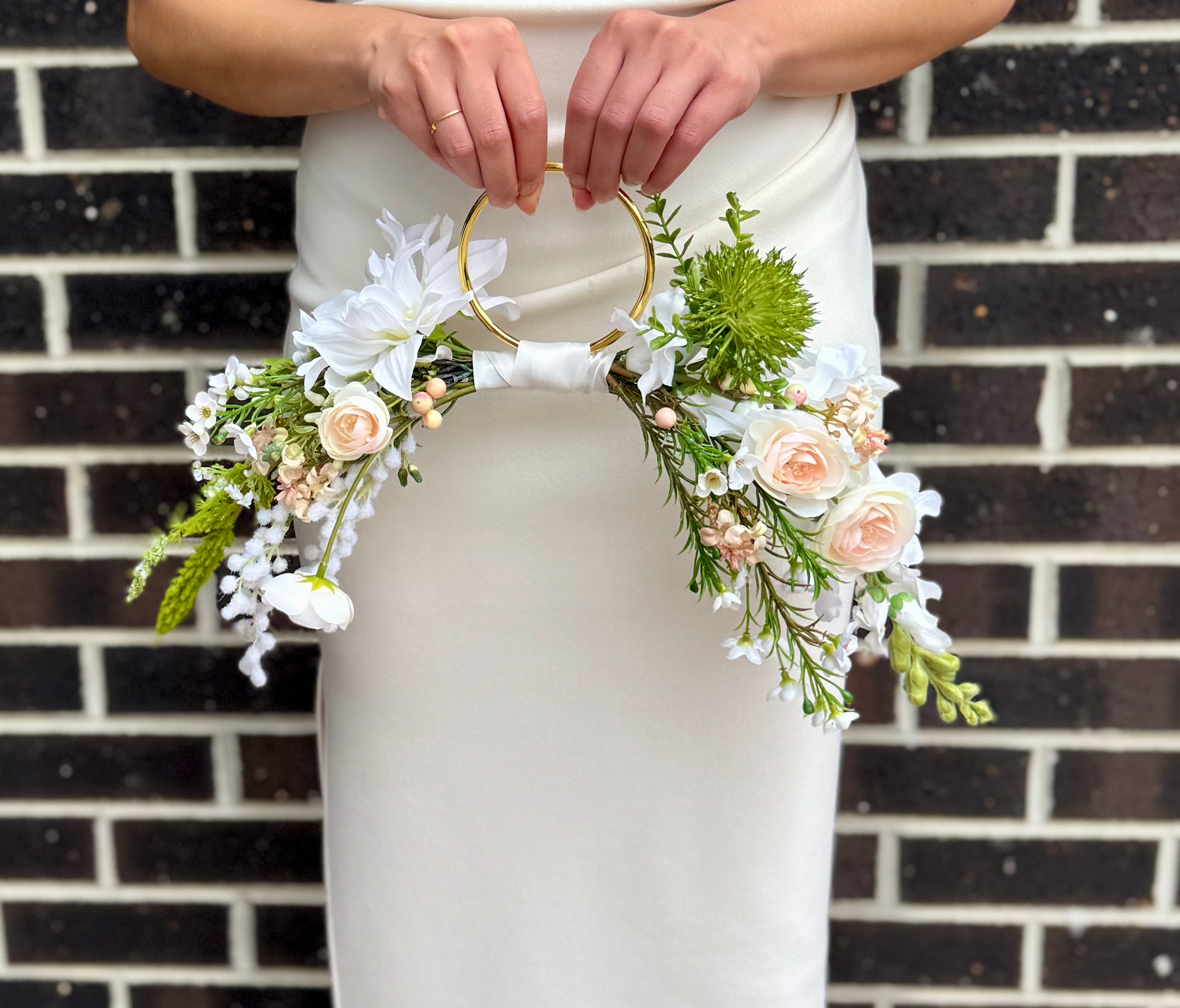 Flower Hoop bouquet on gold ring with artificial white dahlia, blush pink peony, sweet william and green foliage.