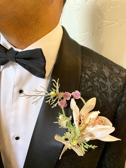Man in bespoke tailored brocade black expensive suit wearing white orchid handmade boutonniere buttonhole.
Handmade with love - affordable luxe in Melbourne. 
No-stress wedding decor. Allergen friendly - no allergy issues as these are not real flowers - artificial silk, real-touch.
New York classic traditional luxe wedding decor. 
Old Luxe American vibes - Australian made.
Bridgerton vibes wedding style.
Perfect for wedding or Christmas.