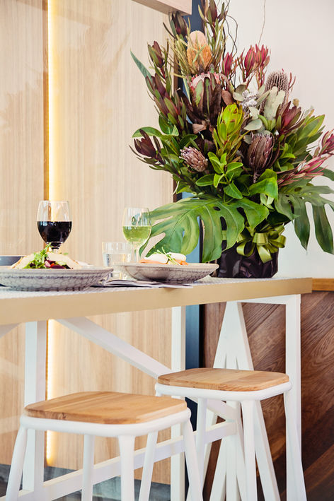 a table with plates of food and glasses of wine