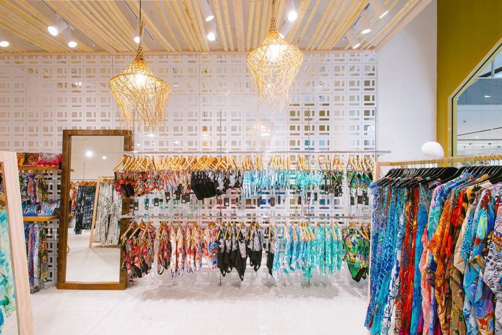 a display of swimsuits and dresses in a store