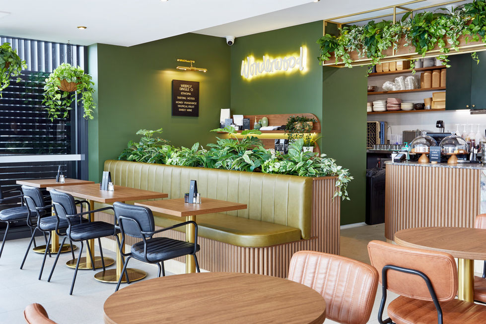 a restaurant with green walls and a sign that says handcrafted
