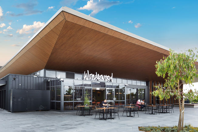 a restaurant called wonderwood has tables and chairs outside