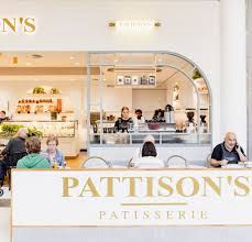 a french patisserie & cafe, with people sitting at tables