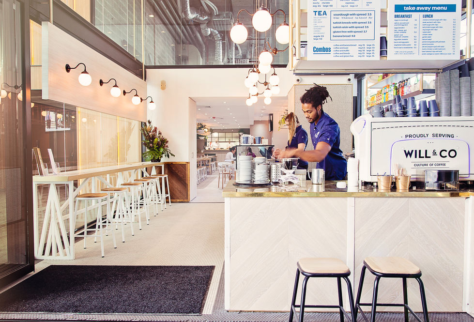 a man behind a counter with a menu that says combos