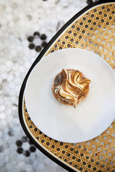 a white plate with a dessert on it on a wicker table