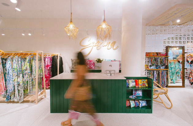 a woman walking in a store with a hp computer