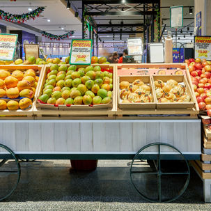a display of mangoes and apples with a sign that says special