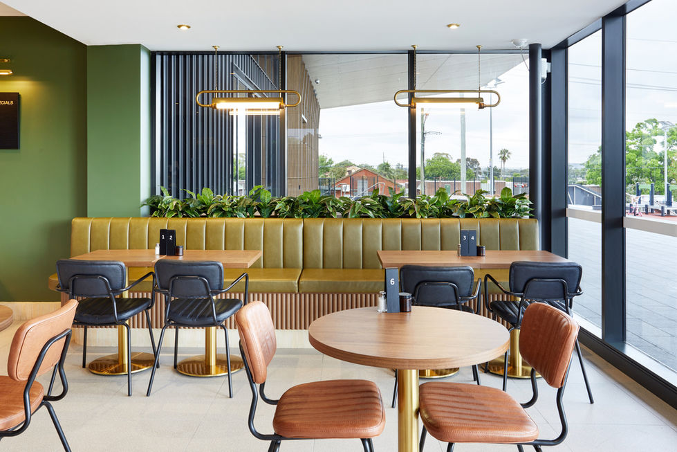 a restaurant with tables and chairs and a sign that says ' g ' on it