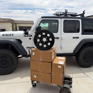 with boxes of new wheels with one sitting on top out of the box.