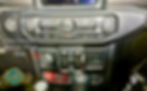 Car dashboard with controls. Text reads "Brake Controller replaces 12 volt outlet." Black and silver colors dominate the panel display.