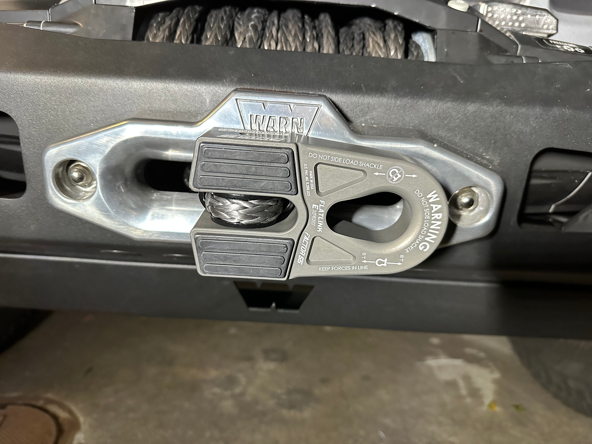 Factor 55 Flat Link installed on end of winch line sitting against the bumper