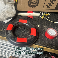 New coil spring retainer with double sided tape used to aid in installation of DIY Jeep Mopar Bilstein  lift kit.