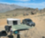 Xventure off-road trailer with springbar Autofly installed. There is Jeep Gladiator and a Maggiolina Roof Top Tent in view.