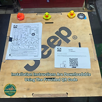 DIY instructions for Mopar Bilstein Lift Kit Install laying on top of Jeep parts crate, text and muddy ruttzz logo visible.