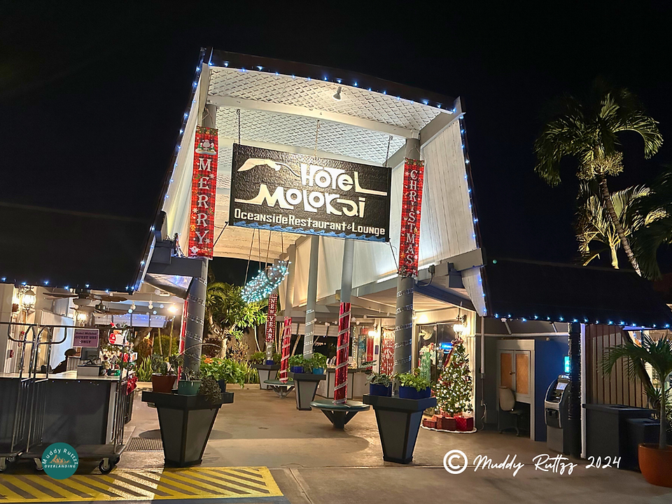 Molokai Hotel and Restaurant. Sign says Oceanside Restaurant And Lounge.  in the front. Hotel is decorated for Christmas.