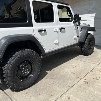 Toyos, Steelies On Wrangler Jeep sitting in driveway