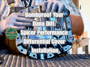 Gloved hand holding Dana Spicer Performance Diff Cover with text that says "Bombproof Your Dana Diff: Spicer Performance Differential Cover Installation"