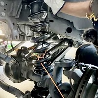 Installing the new coil spring and lower bump stop DIY Jeep lift kit install 