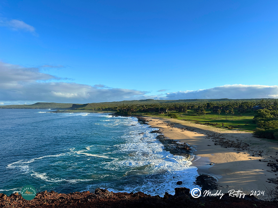 Kepuhi Beach and Kepuhi Bay seen from Kaika Rock  with waves breaking on the sandy beach.