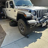 Jeep Gladiator rear is supported with jack stands with with wheels removed to perform DIY Bilstein Reservoir shock lift kit installation.