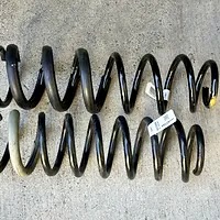 Comparing lengths of stock and new coil springs included in the DIY Mopar Jeep Bilstein lift kit.