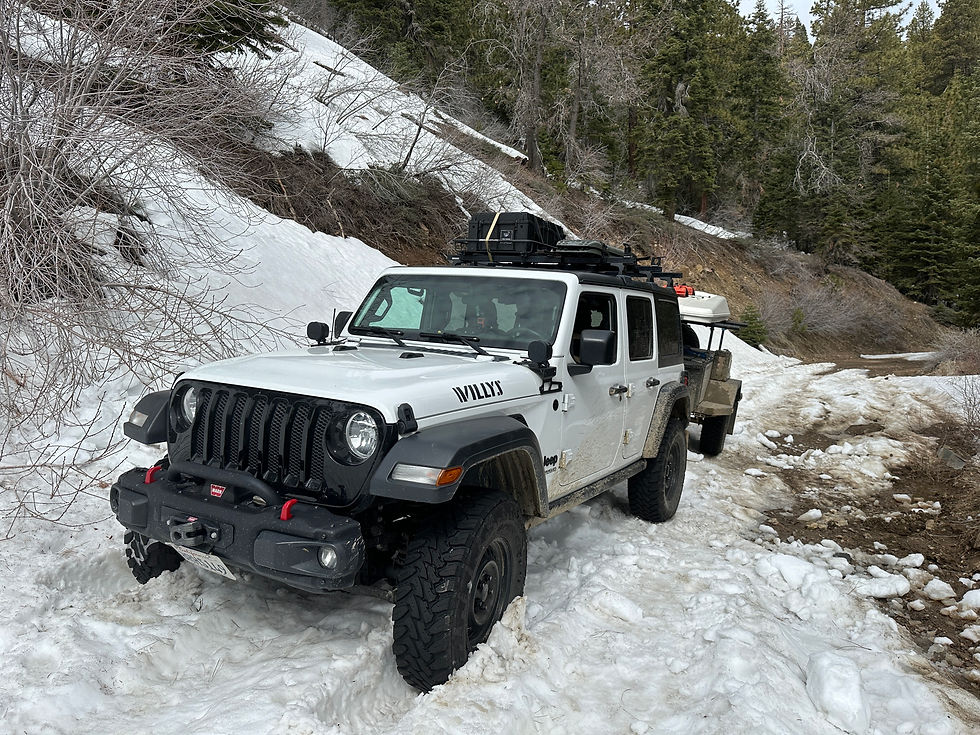 Jeep Wrangler Willys stuck in the snow on a mountain road