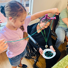 Piper helping a resident with a craft