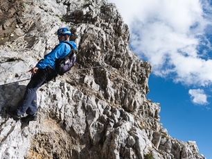 Via ferrata dolomitica, estate 2020. Hero: corpo in azione sulla parete, tensione fisica, nessun volto identificabile.