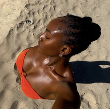 What in the glow-up is “Melanin Maxing”...And Why More Black Women Are Tanning