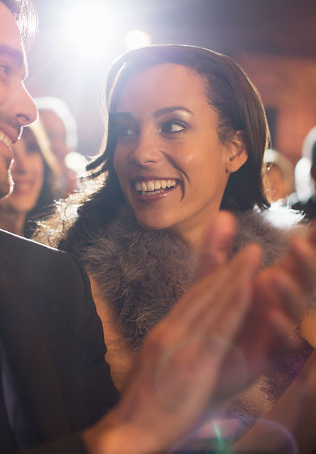 Close up of couple clapping in theater