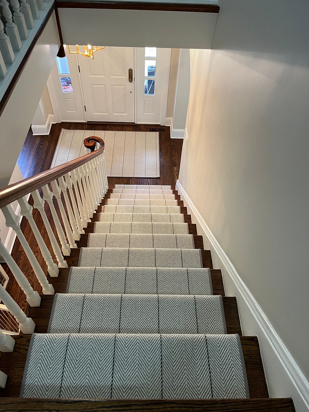Carpeted staircase leading to a front door