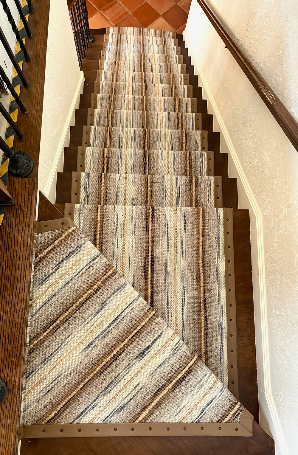Staircase with striped carpet runner