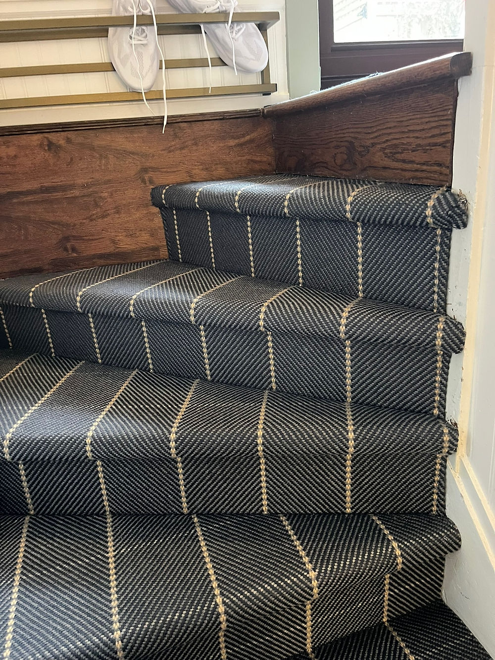 Staircase with dark striped carpet