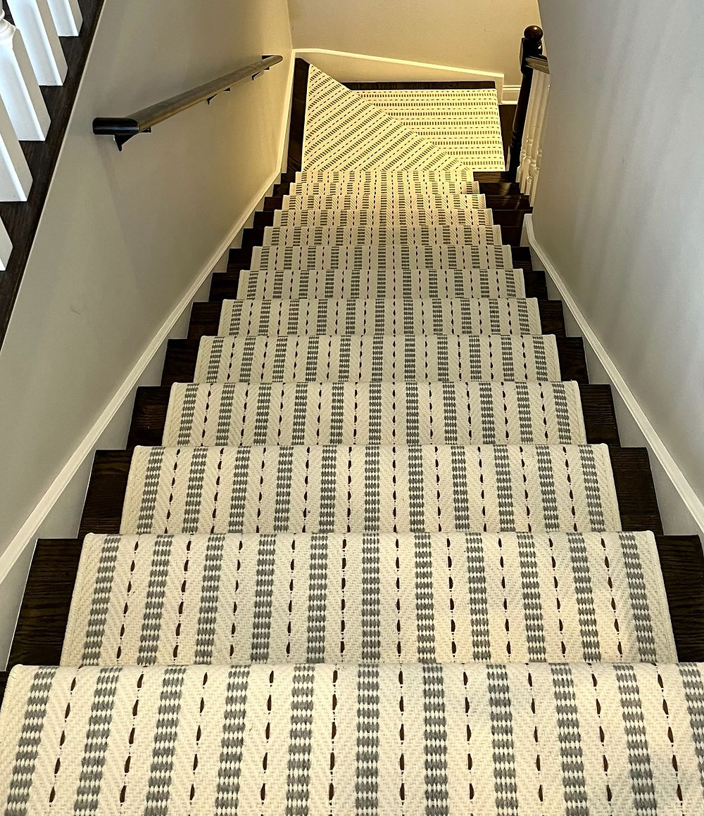 Dark wood staircase with a patterned carpet runner