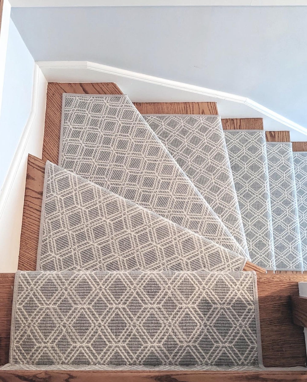 Staircase with grey geometric patterned runner
