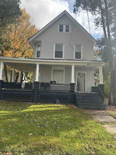 A light blue, two story house.