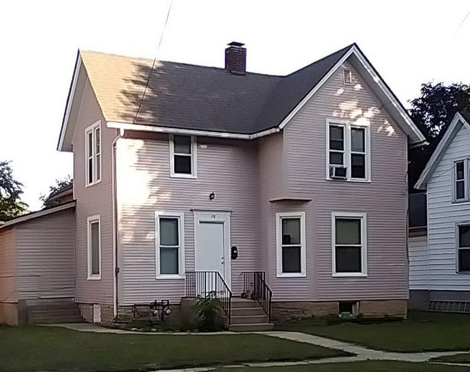 A soft blue, two story house.