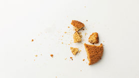 A crumbled cookie representing the fragile spreadsheet systems food brands rely on for cost tracking