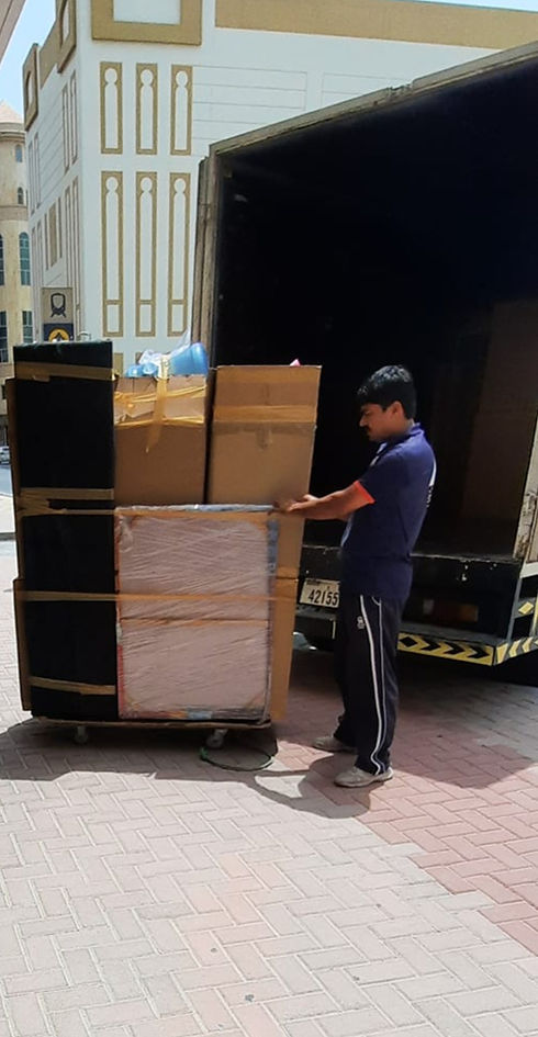 Professional mover packing and loading cargo boxes in Dubai - Imran Quick Movers team handling secure residential relocation.