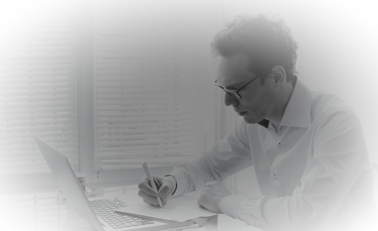 A man buried in work at his desk — where productivity begins to blur with exhaustion.