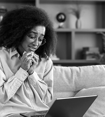 Individual in a virtual therapy session, receiving support