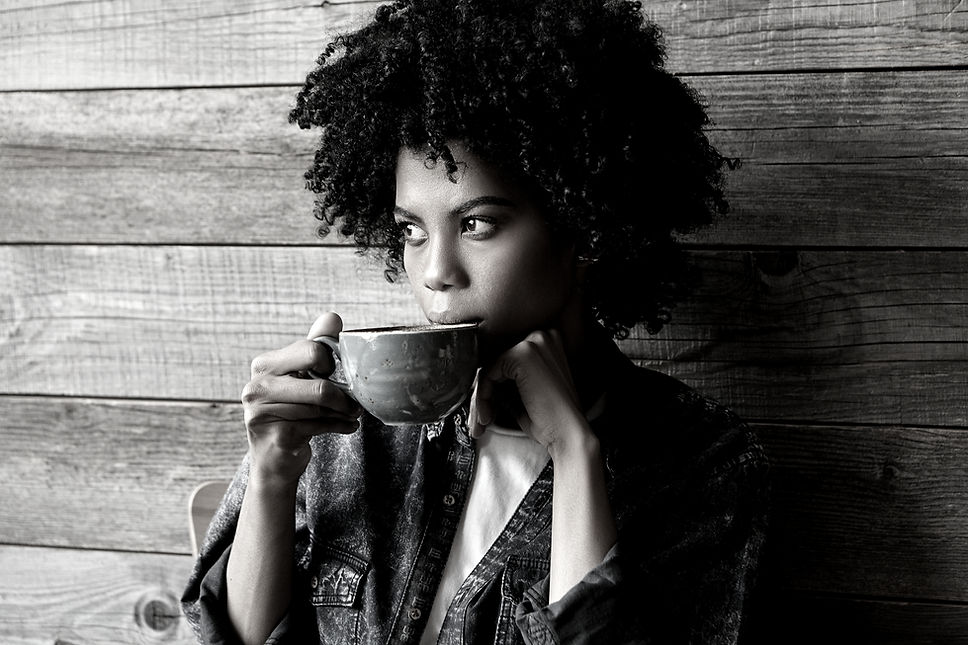 Woman looking outside with coffee