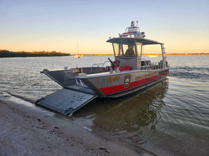 beached fireboat with landing bow door down at sunset