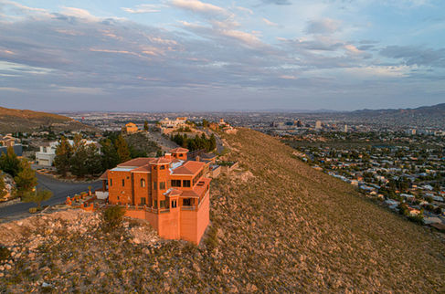 Orange hillside house overlooking city