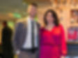 corporate magician spencer grey next to woman in red dress at holiday party