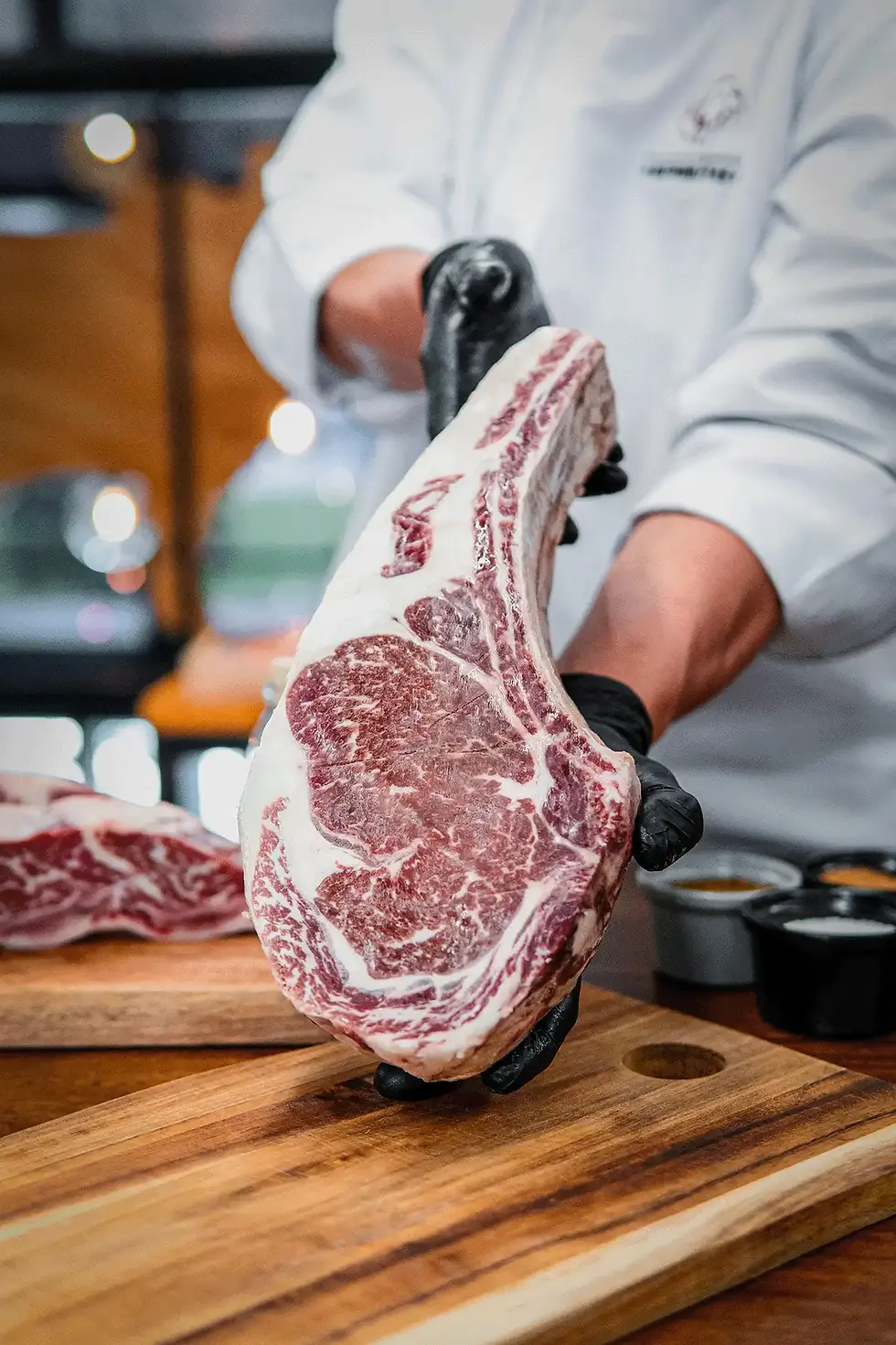 chef-is-cutting-up-piece-meat-wooden-cutting-board