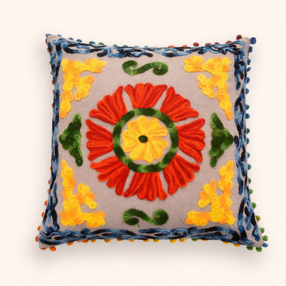 Mira 16x16 vibrant red and yellow sunburst Suzani cushion cover by ZivaraJewels with multi-coloured pom-poms.