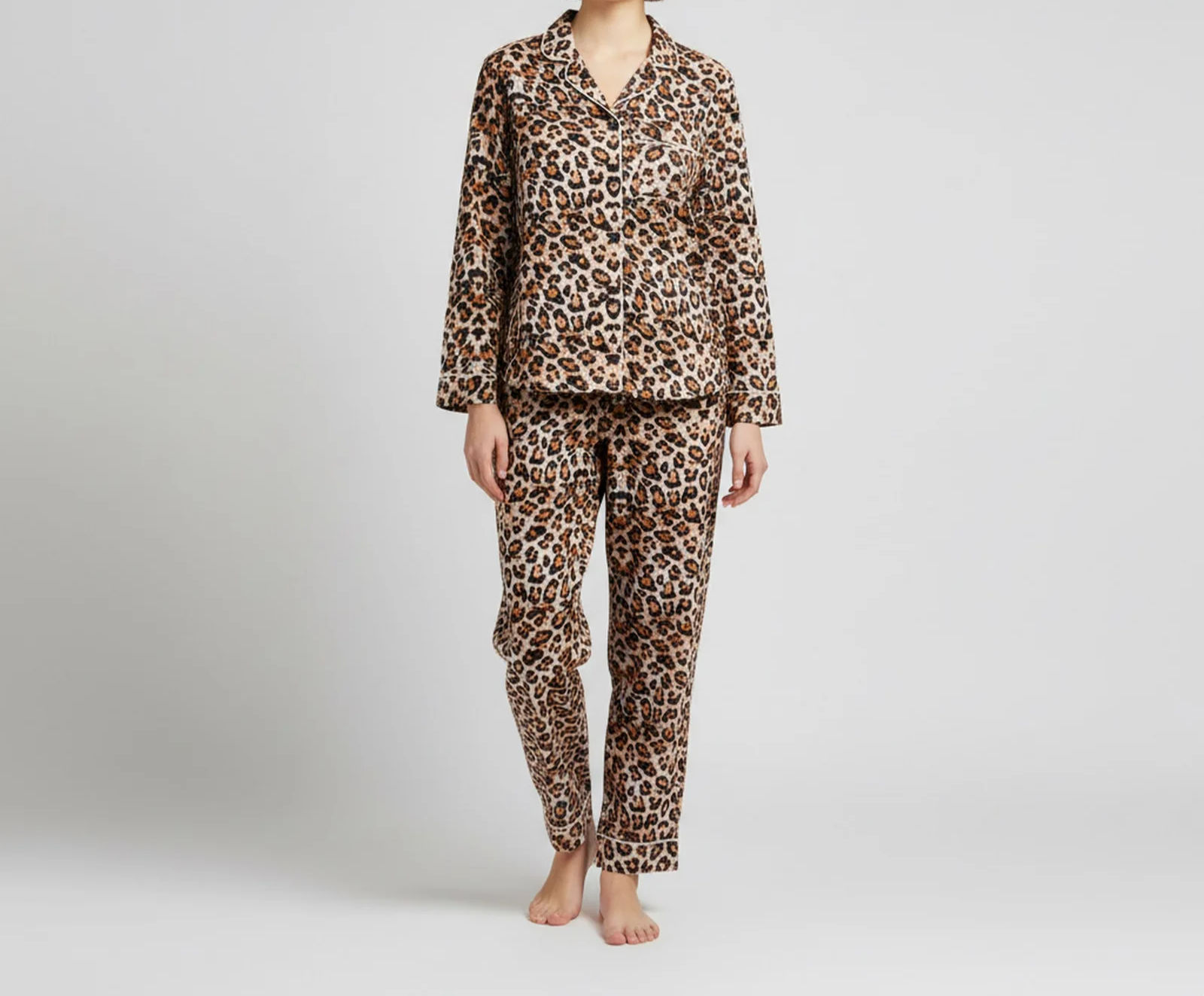 Woman wearing leopard print cambric cotton PJ set with long sleeves and relaxed fit sleepwear.