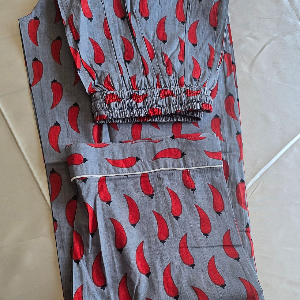 Thumbnail: Woman wearing  red chilli cambric cotton PJ set with long sleeves and relaxed fit sleepwear.